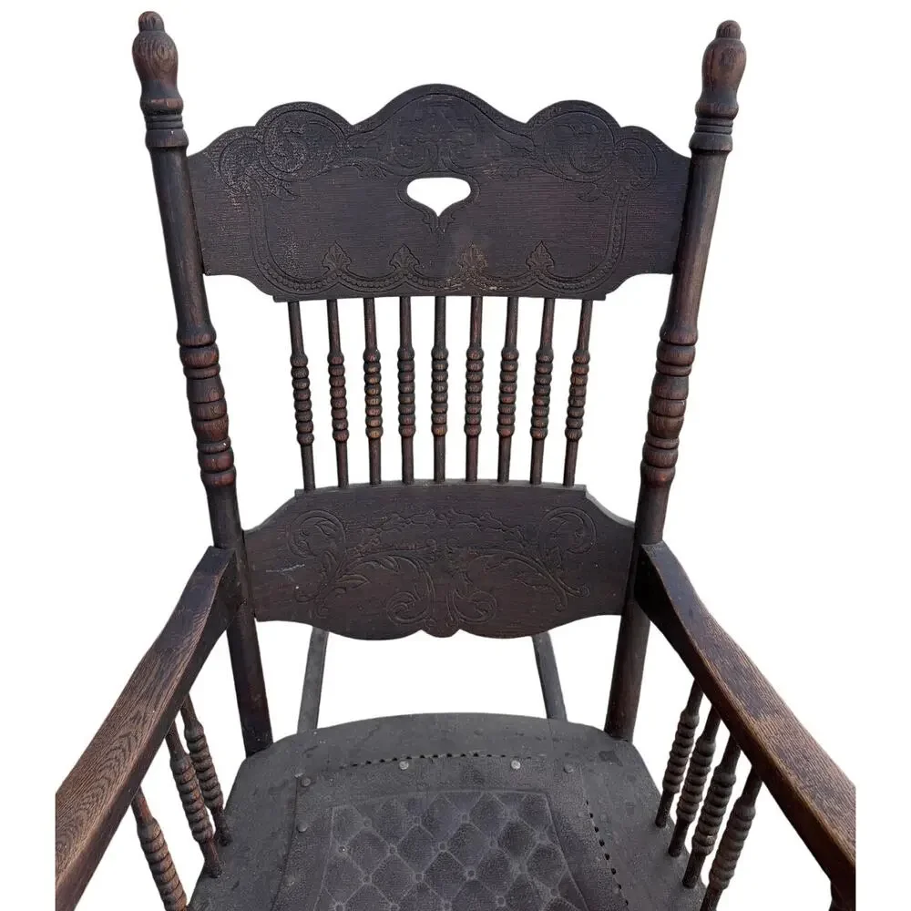 Antique Spindle Rocking Chair With Carvings and Cutout accent